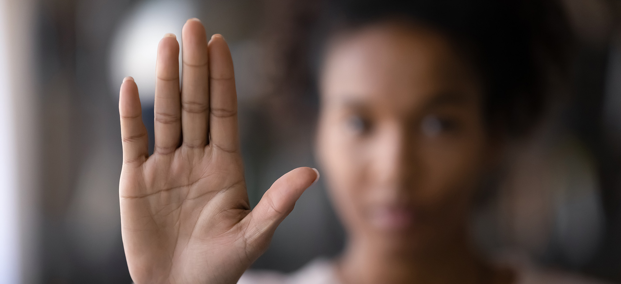 woman holding up hand