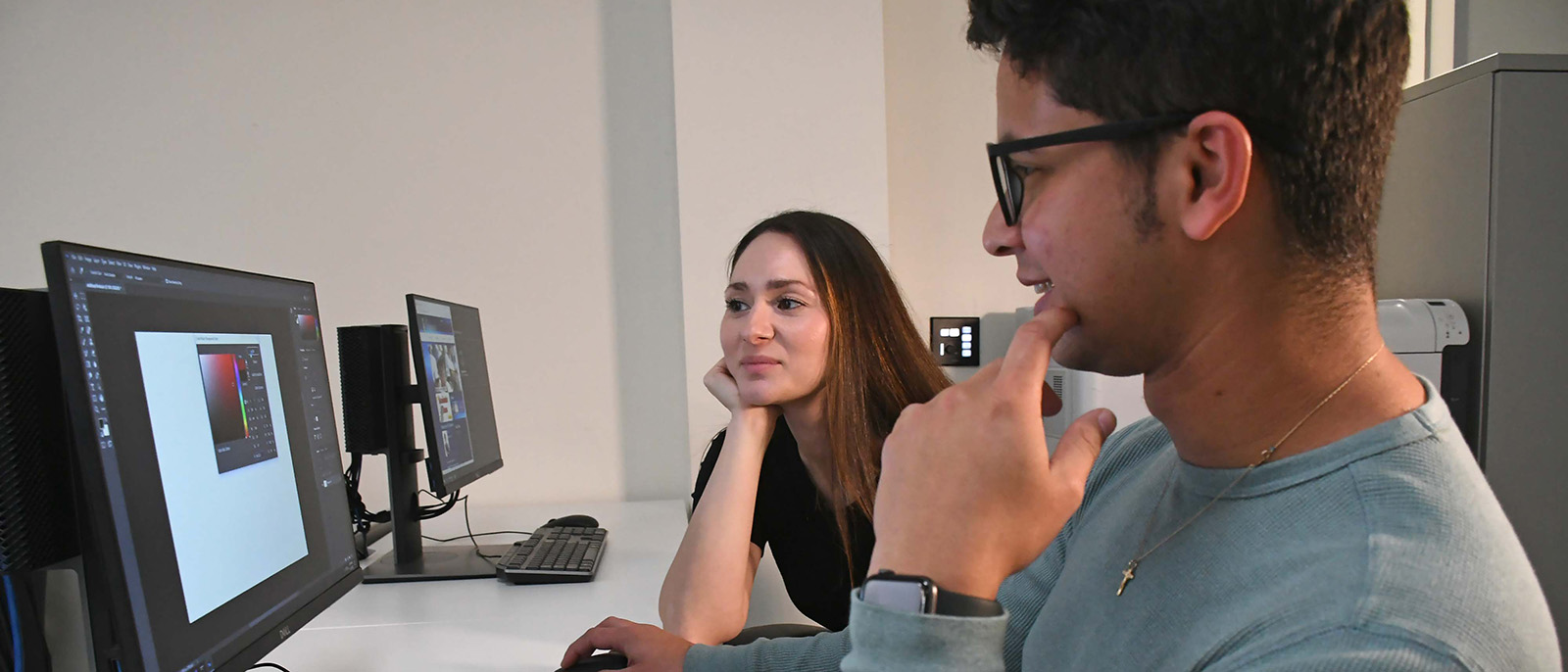 guy and girl smiling at computer