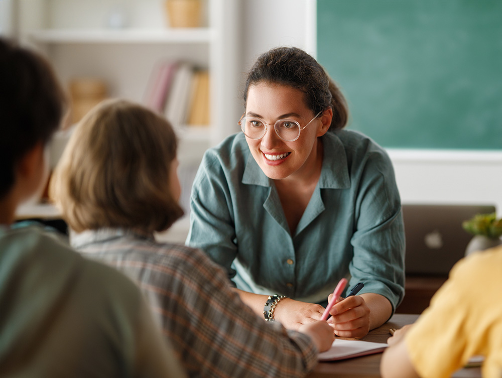 Teacher in front of class whiteboard