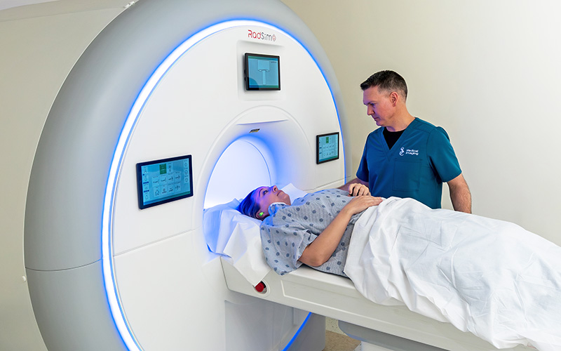 MRI student Chad Whitneck training on MRI machine