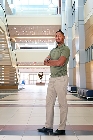 STEM student Lorenzo Lewis standing in science building atrium